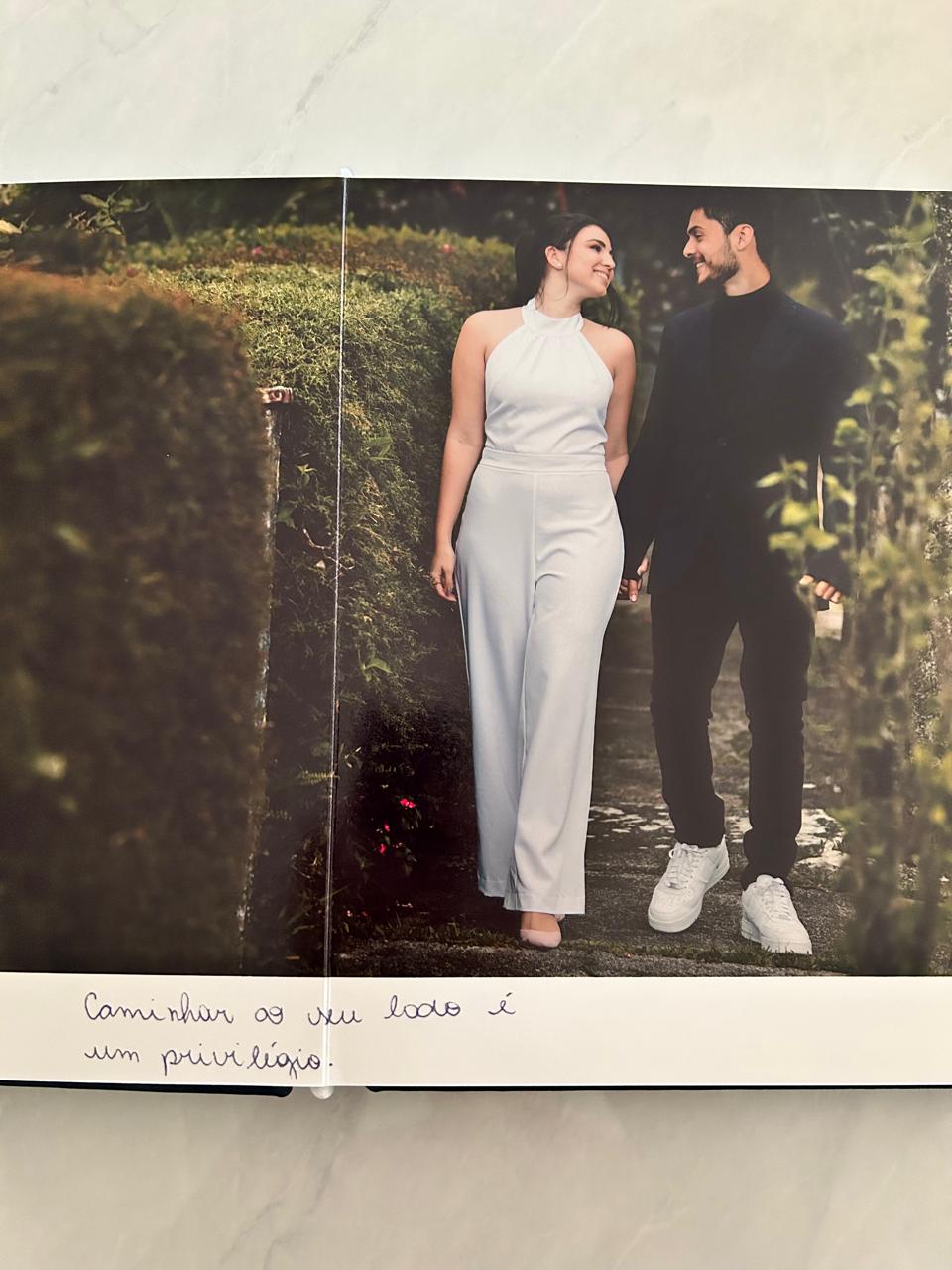 Páginas do álbum com fotografia do casal e trecho dos votos escrito à mão